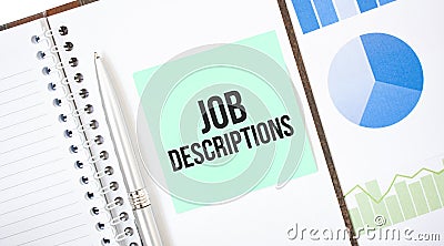 Green card on the white notepad. Text Job Descriptions. Business concept Stock Photo