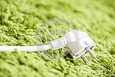 Green carpet on Power Plug Saving energy Stock Photo