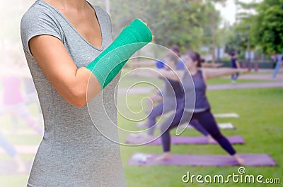 Green cast on hand and arm on blurred background woman fitness g Stock Photo