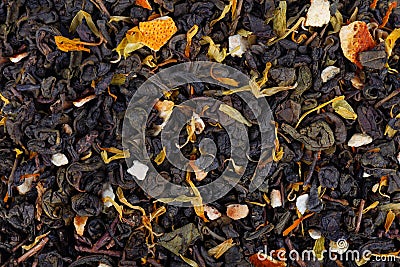 Green Ceylon tea with dry flowers and candied orange background. Stock Photo