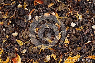 Green Ceylon tea with dry flowers and candied orange background. Stock Photo