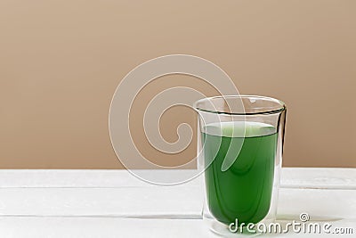 Green chlorophyll drink in a glass on white table Stock Photo
