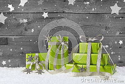 Green christmas background on grey wooden background with snow. Stock Photo