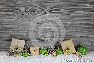 Green Christmas presents wrapped in natural paper on old wooden Stock Photo