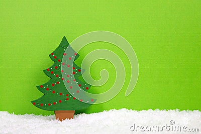 Green christmas tree on a snowy background. Stock Photo