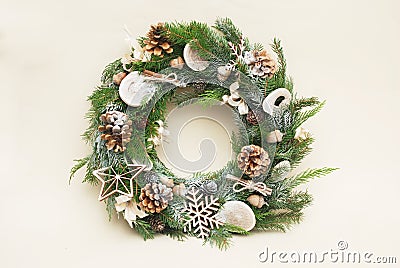 Green christmas wreath with decorations isolated on white background. Eco style with natural accesories: pinecones Stock Photo