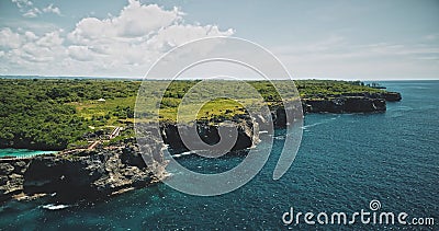 Green cliff shore of sea bay with emerald lake on top. Amazing wild nature landscape of tropic trees Stock Photo