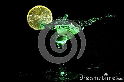 Green cocktail splashing in a glass Stock Photo