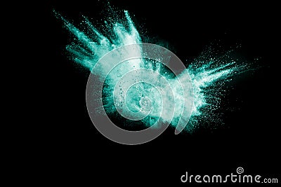 Green color powder explosion cloud isolated on black background. Stock Photo
