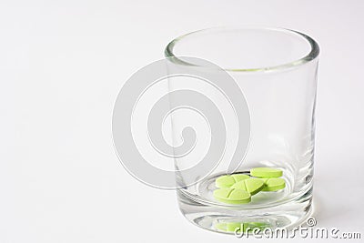 Green color tablet pills in glass on white background Stock Photo