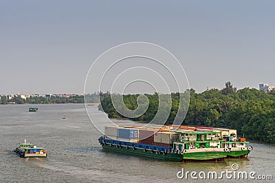 Green container barges on Song Sai Gon river, Ho Chi Minh City, Vietnam Editorial Stock Photo