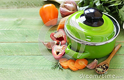 Green cooking pot and ingredients for soup or stew Stock Photo
