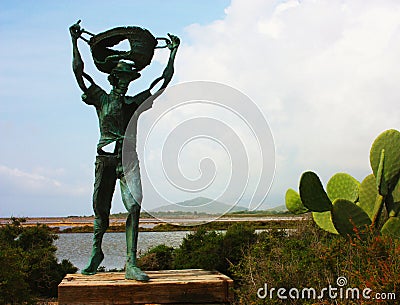 Green copper statue of the old salt worker in the salt flats in ibiza Editorial Stock Photo