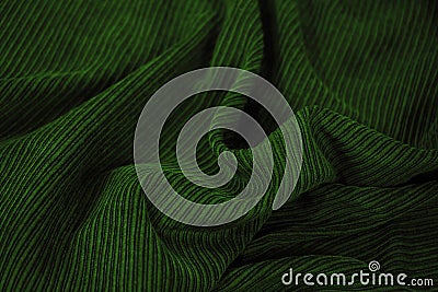 Green corduroy. Soft folds of fabric. Elegant background with copy space Stock Photo