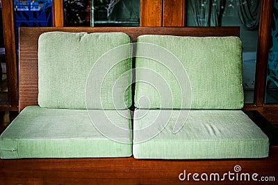 Green cushion on wooden sofa chair. living design for home Stock Photo