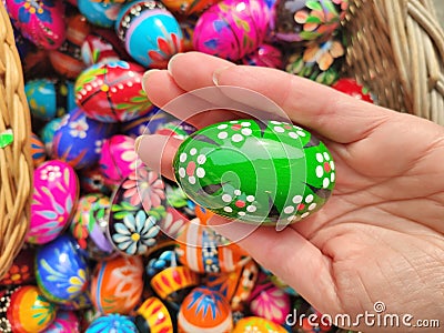 Green decorated Easter egg in hand on traditional Easter market in Krakow Stock Photo