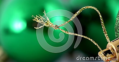 Green decorative christmas ball detail. gold colored hanging rope.macro shot in studio, Stock Photo