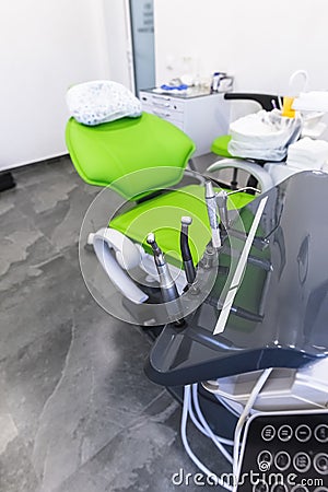 Green dental chair and medical equipment at the dental clinic. The concept of healthcare and treatment in medical Stock Photo