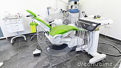 Green dental chair and medical equipment at the dental clinic. The concept of healthcare and treatment in medical Stock Photo