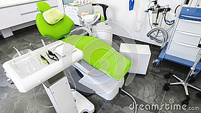 Green dental chair and medical equipment at the dental clinic. The concept of healthcare and treatment in medical Stock Photo