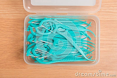 Green dental floss picks in plastic box Stock Photo