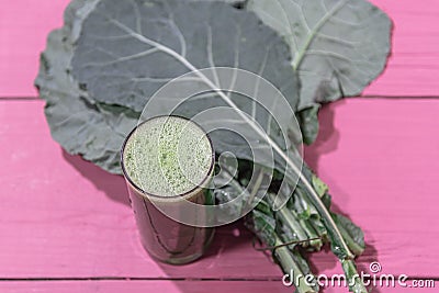 Green detox juice from cabbage leaves on pink background Stock Photo