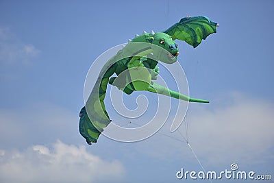 Green dragon shape kite. Editorial Stock Photo