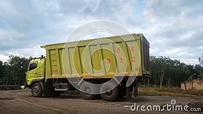 Green Dumptruck parking Editorial Stock Photo