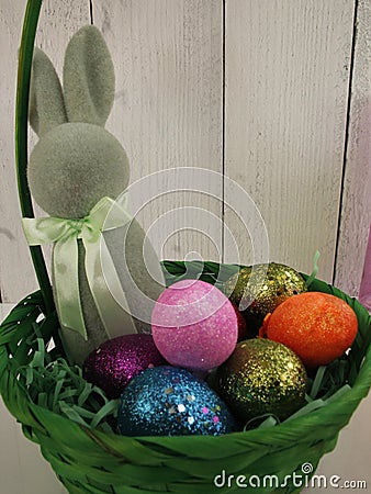 Green easter basket, green bunny, sparkly colorful bright eggs Stock Photo