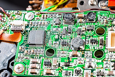 Green electronic board with many capacitors and resistors close-up. Electronic camera chip Stock Photo