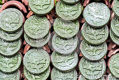 Green embossed flower ceramic pattern on roof tiles Stock Photo