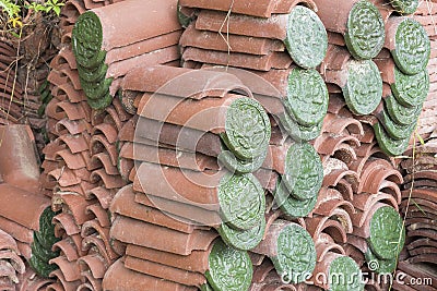 Green embossed flower ceramic pattern on roof tiles Stock Photo