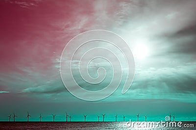 Green energy fighting global warming. Surreal sky wind turbine border image Stock Photo