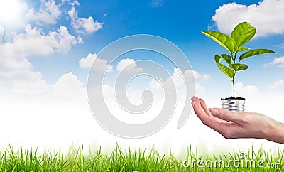 Green energy symbol over blue sky Stock Photo