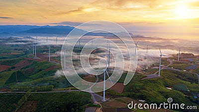 Green Energy Wind Turbine, Aerial view sunrise from Drone flying Stock Photo