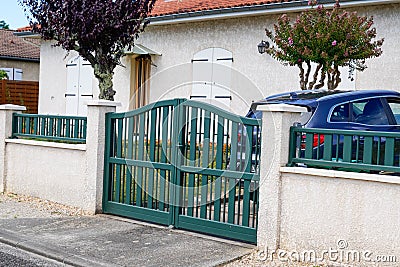 Green entrance portal design on home metal aluminum gate front of suburb door house Stock Photo