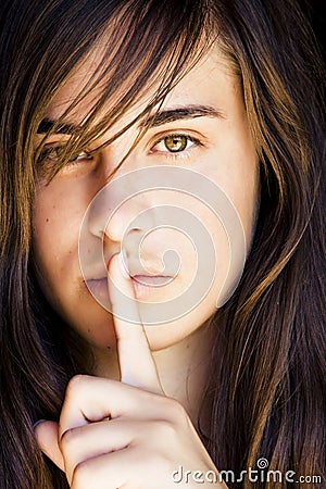 Green eyed woman requesting silence Stock Photo