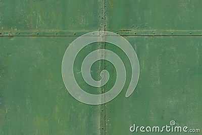 Green faded metal wall with cross from metal stripes on the middle Stock Photo