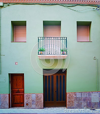 Green faÃ§ade and Balcony with two vases in Figueres Stock Photo