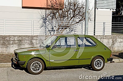 Green Fiat 127, supermini car of the Seventies at the roadside. Editorial Stock Photo