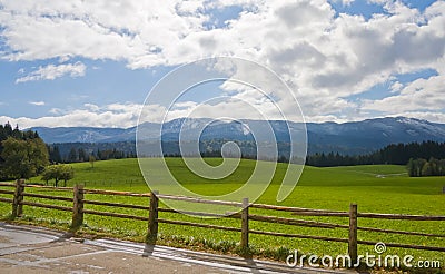 Green field with wooden fence in Bavaria Stock Photo