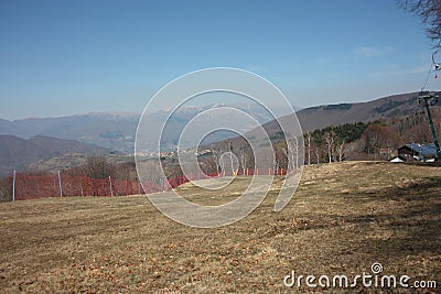 Green fields. ski slopes seen in summer to careggine. paved and green path without snow, dry and arid land in Tuscany Stock Photo