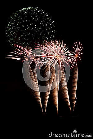 Green fireworks over red and gold Stock Photo