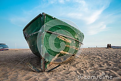 Green fishing boat on the beach and blue sky Stock Photo