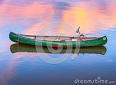 Green Fishing Canoe at Dusk Stock Photo