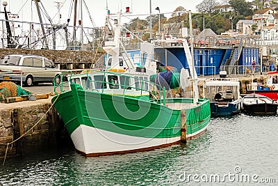 Green Fishing Trawler moored longside the Harbour Wall, Brixham, South Devon Stock Photo