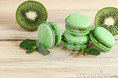 Green french macarons with kiwi and mint decorations Stock Photo