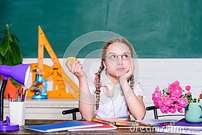 Green fresh ingredients. back to school. Einstein. healthy eating is good. small girl ready to eat apple. Smart child Stock Photo