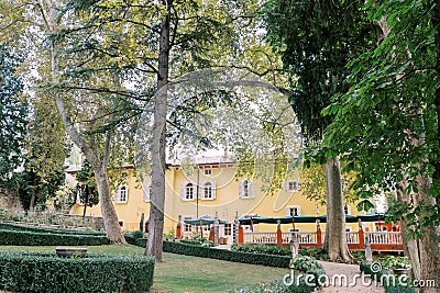 Green garden around the ancient yellow Villa Cordevigo. Verona, Italy Stock Photo