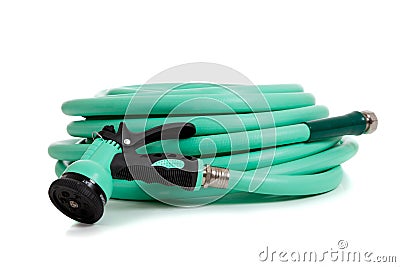 Green garden hose with spray nozzle Stock Photo